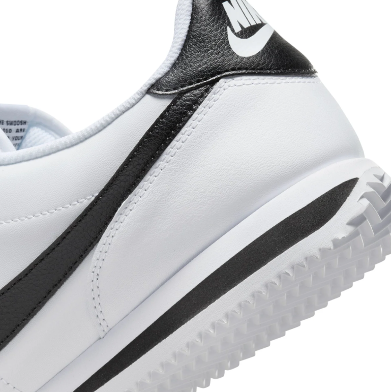 Nike White Low-Top Sneakers with Black Swoosh Details